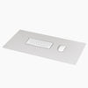 The Minimalist Mat in Gray on a white background with a key board and mouse on it.