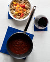 The GIR Navy Flex Mat Set with a pot and glass on it.