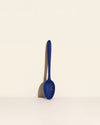 GIR Spoon in Navy on a cream background.
