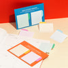 The Poketo Grid Sticky Memos in Cool and warm on a colorful background.