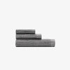 The Onsen Cinder Gray Waffle Bath Towel set on a white background.