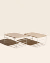 Two Open Spaces Shelf Risers on a cream background.