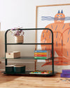 The Open Spaces Dark Green Entryway Rack on a cream background with items displayed on it.
