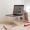 The Open Spaces Shelf Riser with a lap top on it in a workstation.