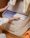 A women storing cloths in the Under bed storage.