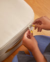 Woman's hands zipping up the Under Bed Storage.
