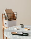 The Open Spaces Dark Green Medium Wire Basket placed on top of the Medium Storage bin on a cream background.
