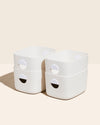 Four Open Spaces Medium Cream Storage Bins on a cream background.