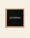 Letterfolk Poet Letter Board in Oak on a cream background.