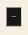 Letterfolk Writer Letter Board in Black on a cream background.