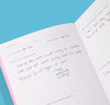 The Quarterly Goal Planner pages with writing on it on a blue background.
