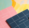Close up of the 18 Month Planner Teal and Pink Planner on a colorful background.