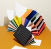 Accordion Pro Filer in Large One open and one closed on a orange surface.