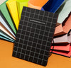 A close up of the Accordion Pro Filer in Large on an orange surface.