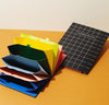 Close up of the Poketo Accordion Pro Filer in Small on a yellow background.
