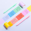 Over head shot of the Notes Sticky Rolls with writing on it on a light purple background.