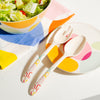 The Bamboo Servers set resting on a Poketo Bamboo Salad plate Plate with a salad in the top left corner.