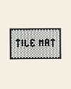 Letterfolk Tile Mat in White on a cream background.