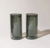 Two 16 oz Gray Double Wall Glasses on a cream background.