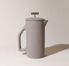 A Matte Gray Ceramic French Press on a cream background.
