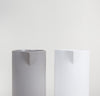 A close up shot of the Matte Gray CeramicFrench Press and Gloss Cream Ceramic French next to each other without the Lid.