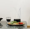 The Clear Pour Over Carafe and Clear Double Wall Glass filled with coffee on a grayish background.