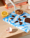 The GIR Studio Ultimate Flip with a cookie on it with chocolate, half a lemon and eggshells around it. 