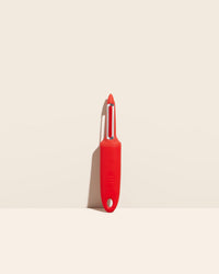 GIR Peeler in Red on a cream background.