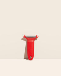 GIR Peeler in Red on a cream background.