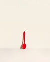 GIR Spoon in Red on a cream background.