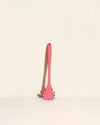 GIR Spaghetti Spoon in Coral on a cream background.