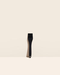 The GIR Black Ultimate Basting Brush on a cream background. 