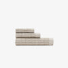 The Onsen Oatmeal Waffle Bath Towel set on a white background. 