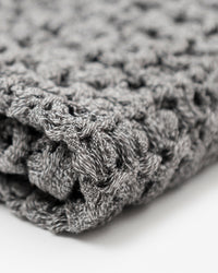 Close up of the Onsen Cinder Gray Waffle Bath Towel.