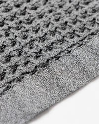 Close up of the Onsen Cinder Gray Waffle Bath Towel.