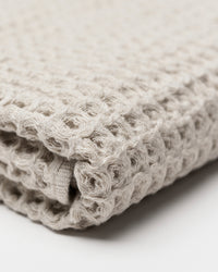 Close up of the Onsen Oatmeal Waffle Bath Sheet on a white background. 
