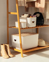 Open Spaces Cream Storage Bins on a wooden rack.  