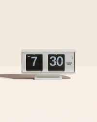 Mid Century Round Flip Clock in White on a cream background.