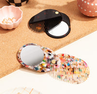 The 2 in 1 Pocket Comb Mirror in Black Amber and Multi Party next to each other. 