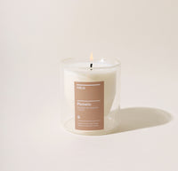 A 6 Oz Pomelo Double wall Candle on a cream background.