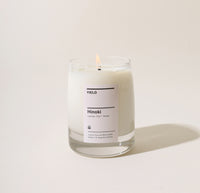 A 8 Oz Hinoki candle on a cream background. 