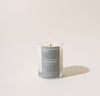 A 2.5 Oz Chamomile candle on a cream background. 